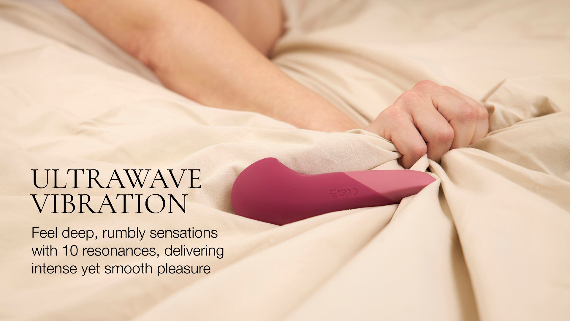 Purple electronic device on a person's lap with text about ultrawave vibration.