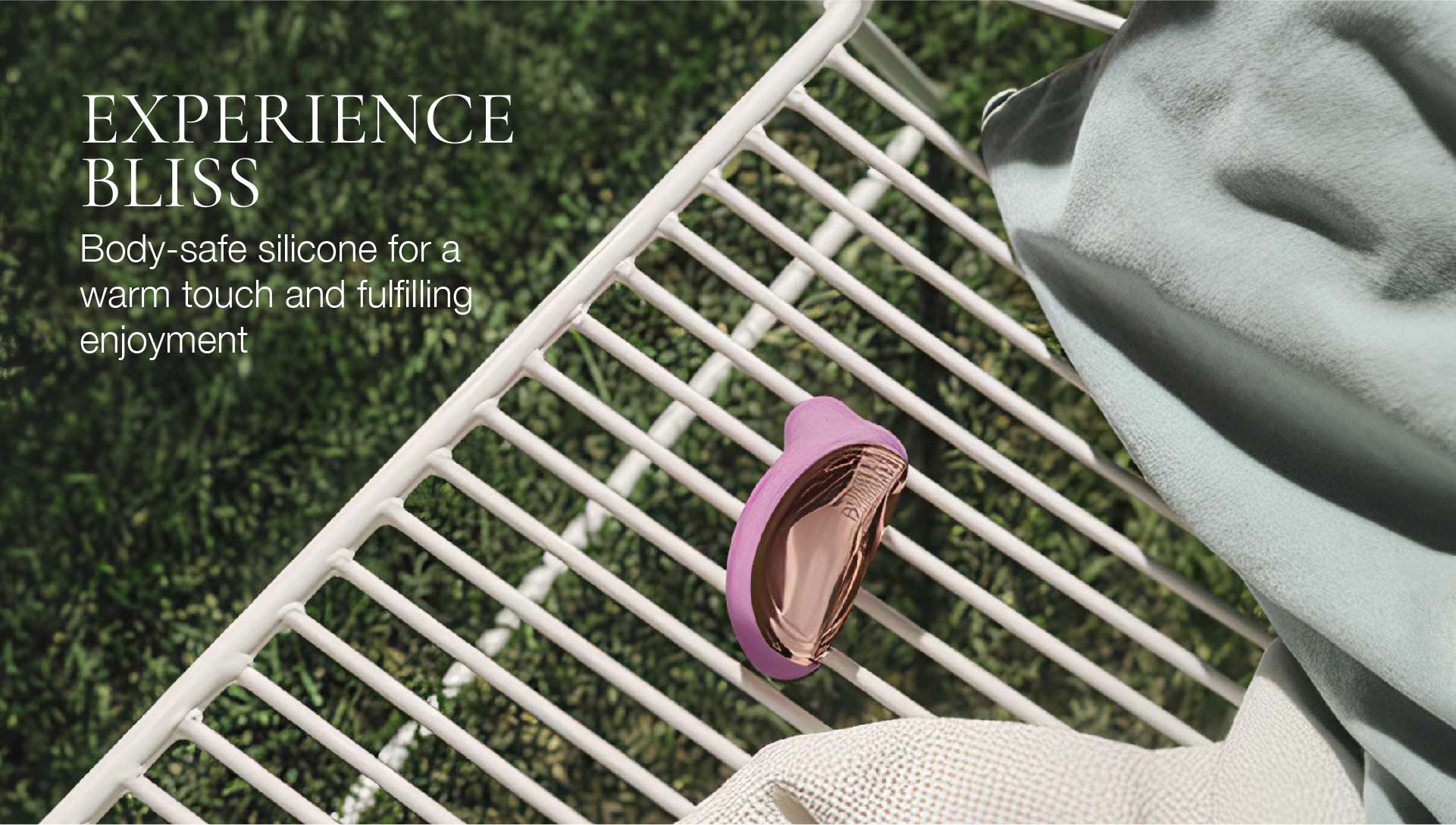 Purple silicone ring on a white metal bench with green grass in the background