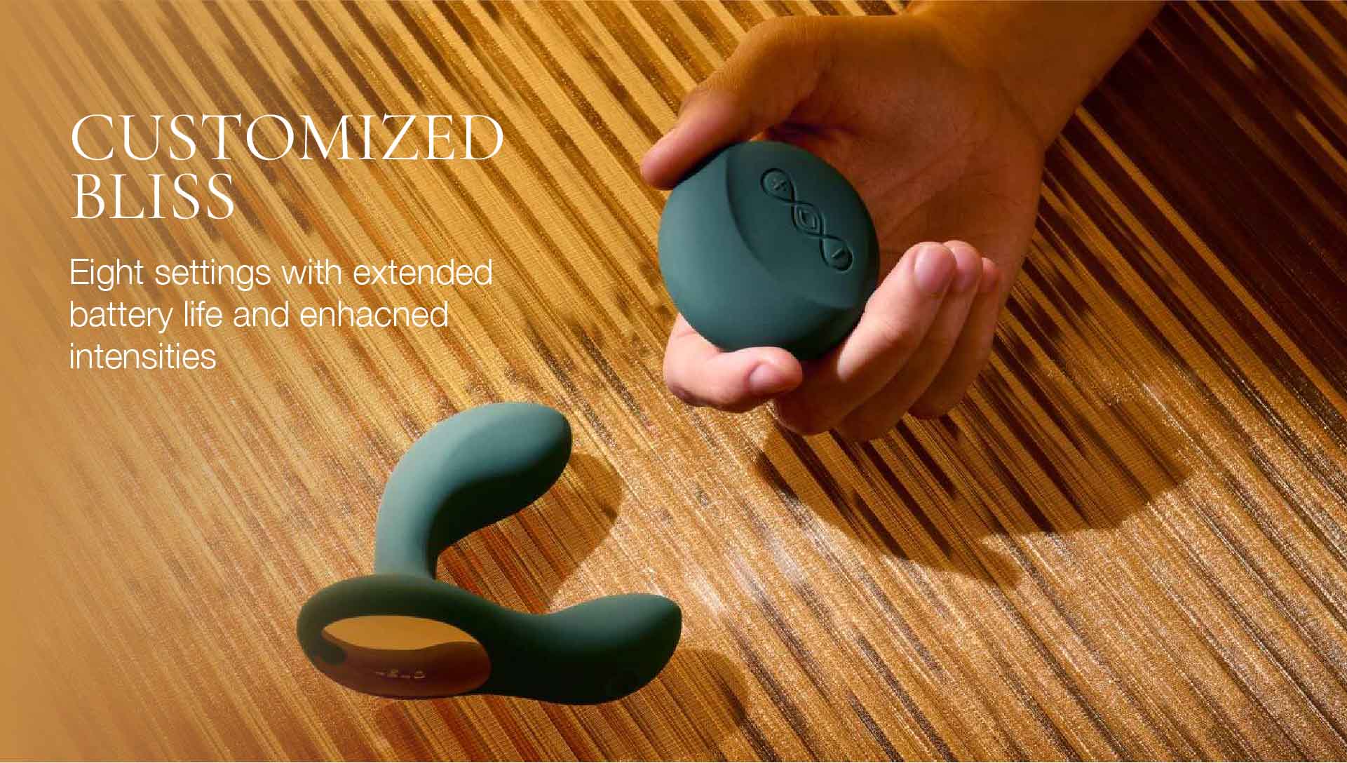 Teal silicone vibrator remote held by a hand on a wooden surface with promotional text.