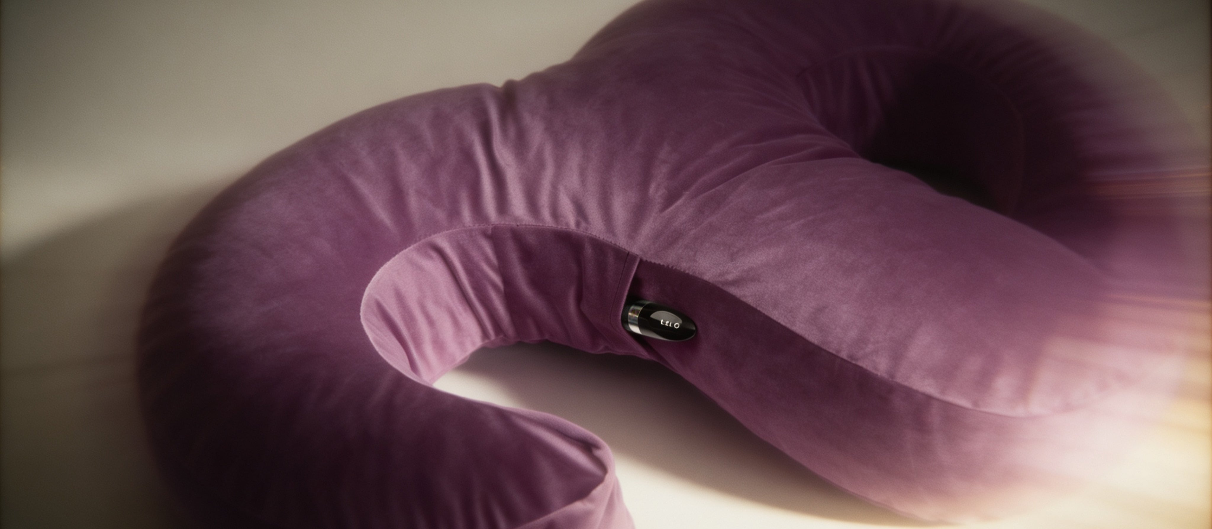 Purple travel snuggle pillow on a light surface