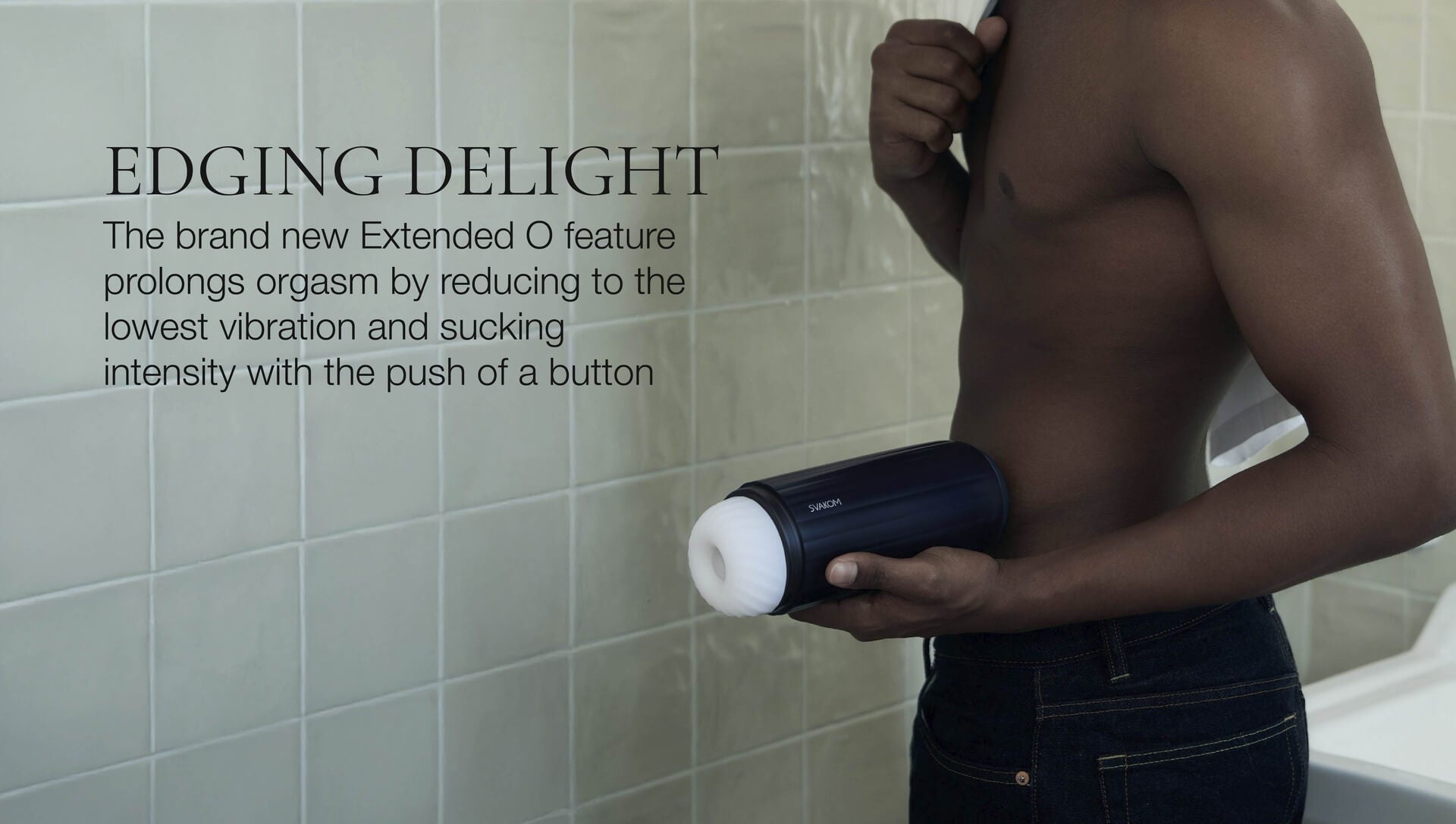 Man holding a cylindrical device with text about an extended O feature in a bathroom setting.
