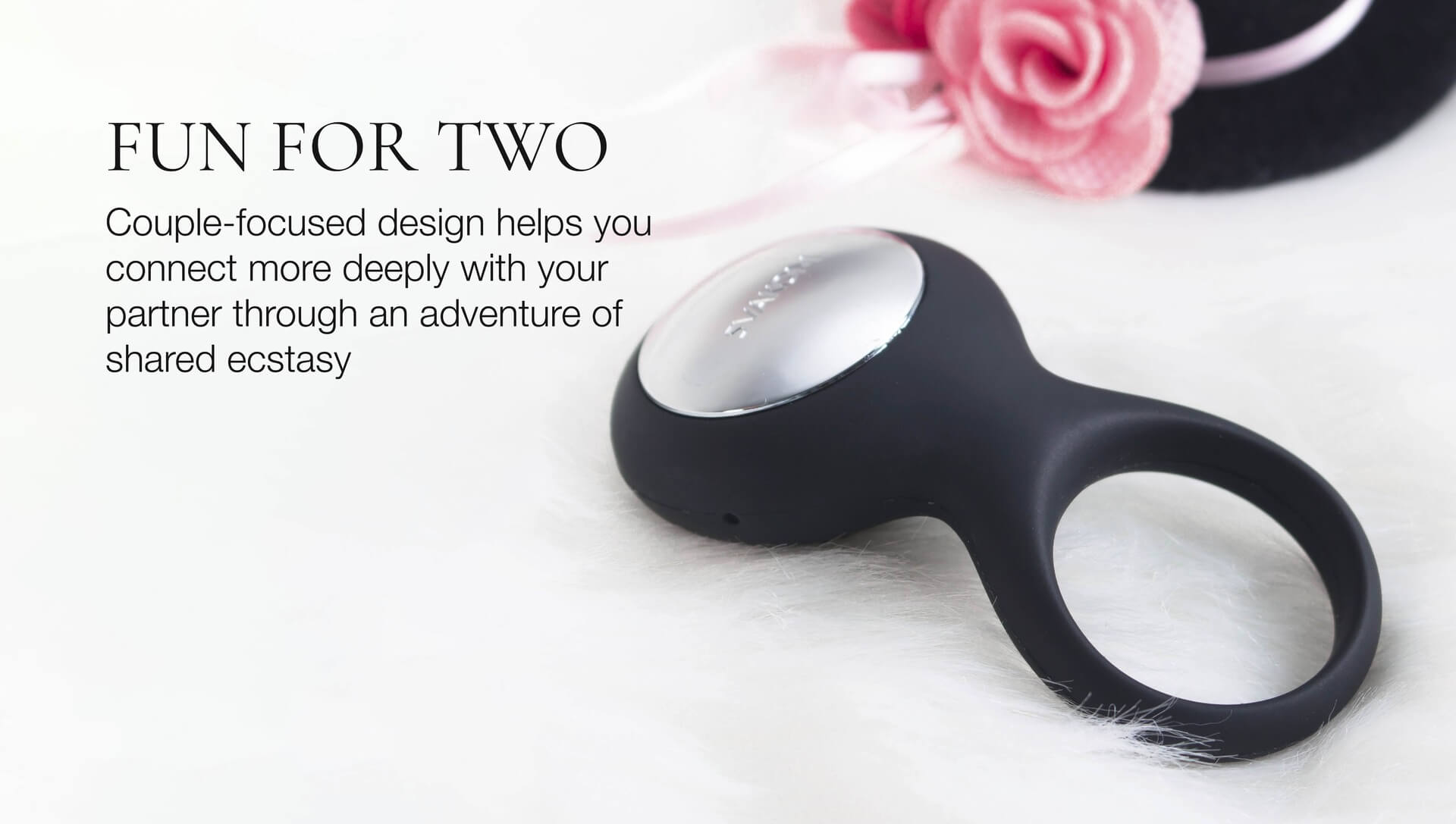 Black and silver cock ring on a white surface with text about couple-focused design.