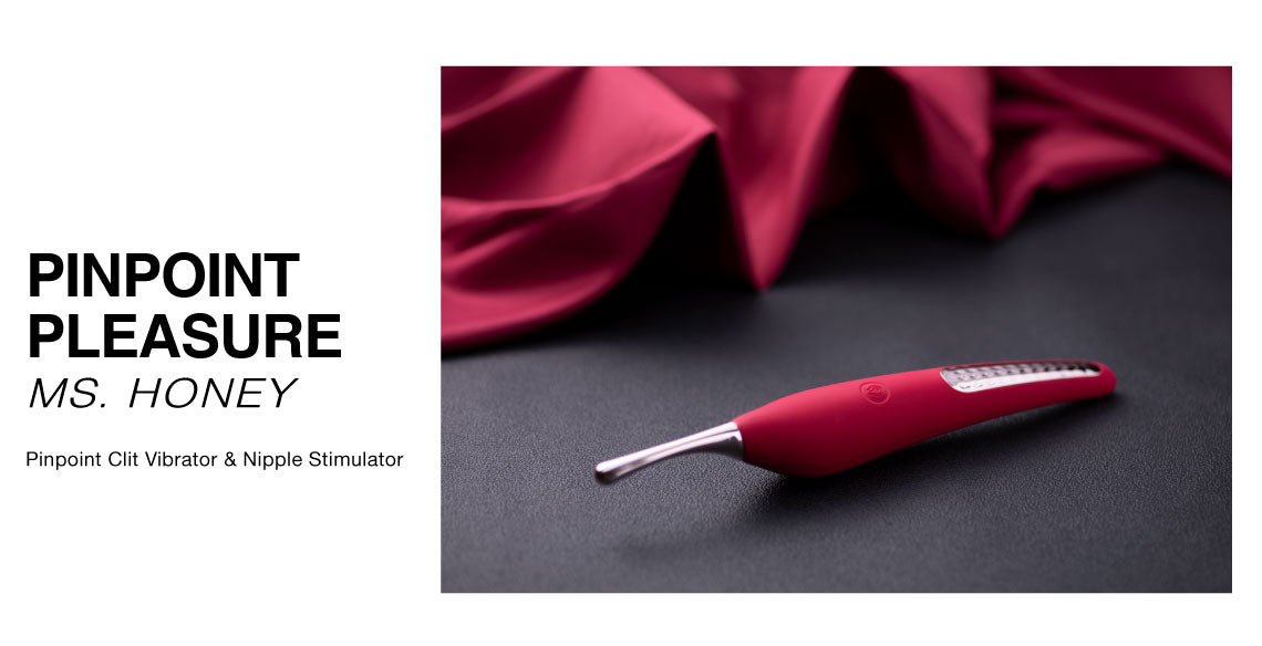 Red clit stimulator on a dark surface with red fabric in the background, branded as 'Pinpoint Pleasure MS. HONEY'.