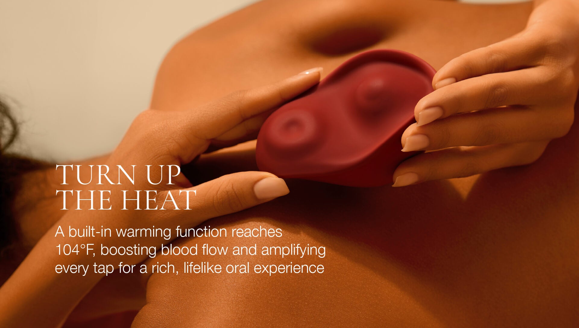 Red silicone vibrator being held by hands with text about warming function