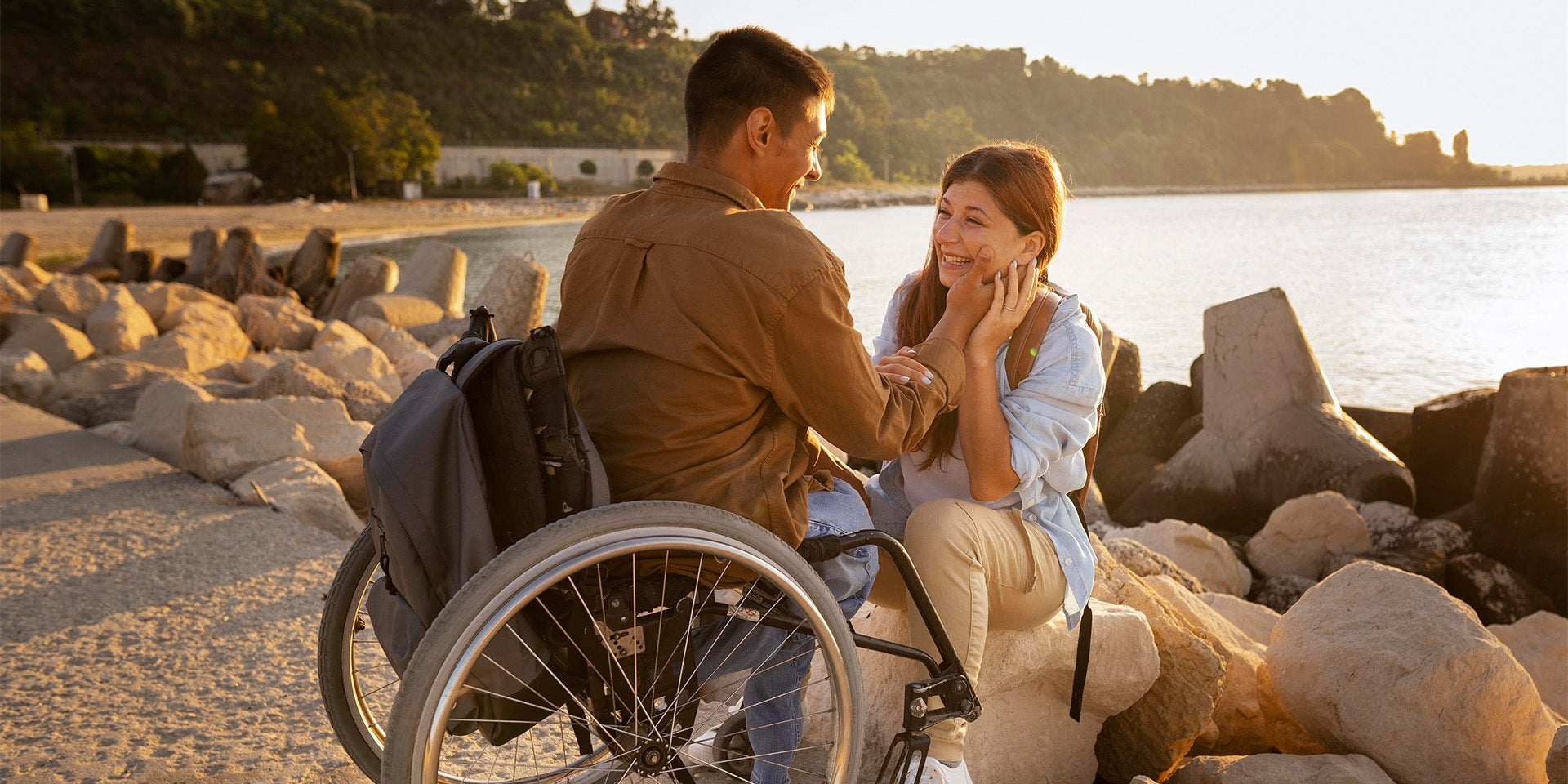 Man in wheelchair holding hands with girlfriend