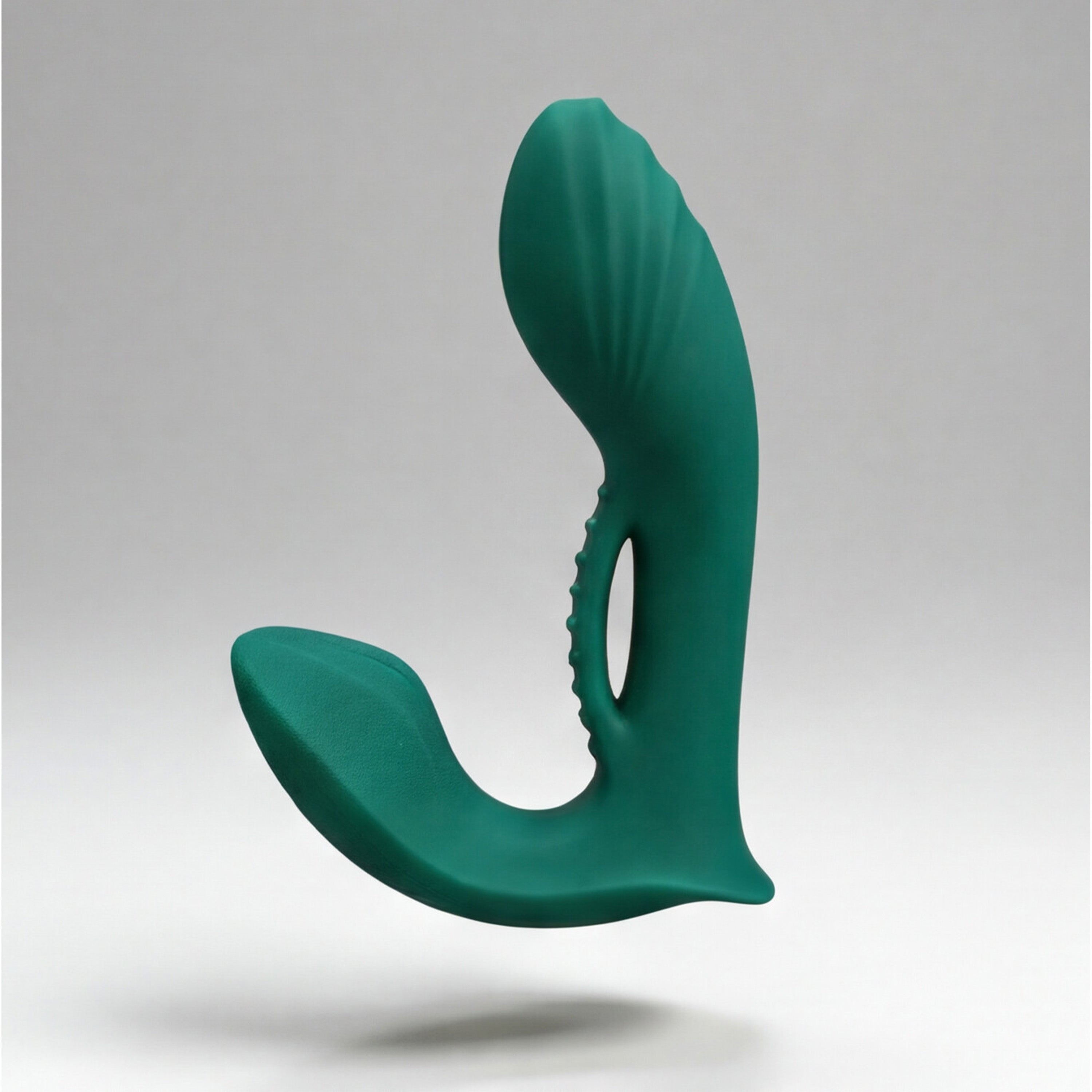Green silicone prostate massager on a gray background