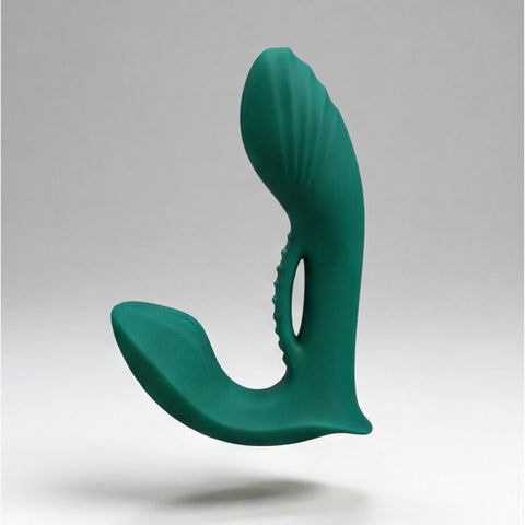 Green silicone prostate massager on a gray background