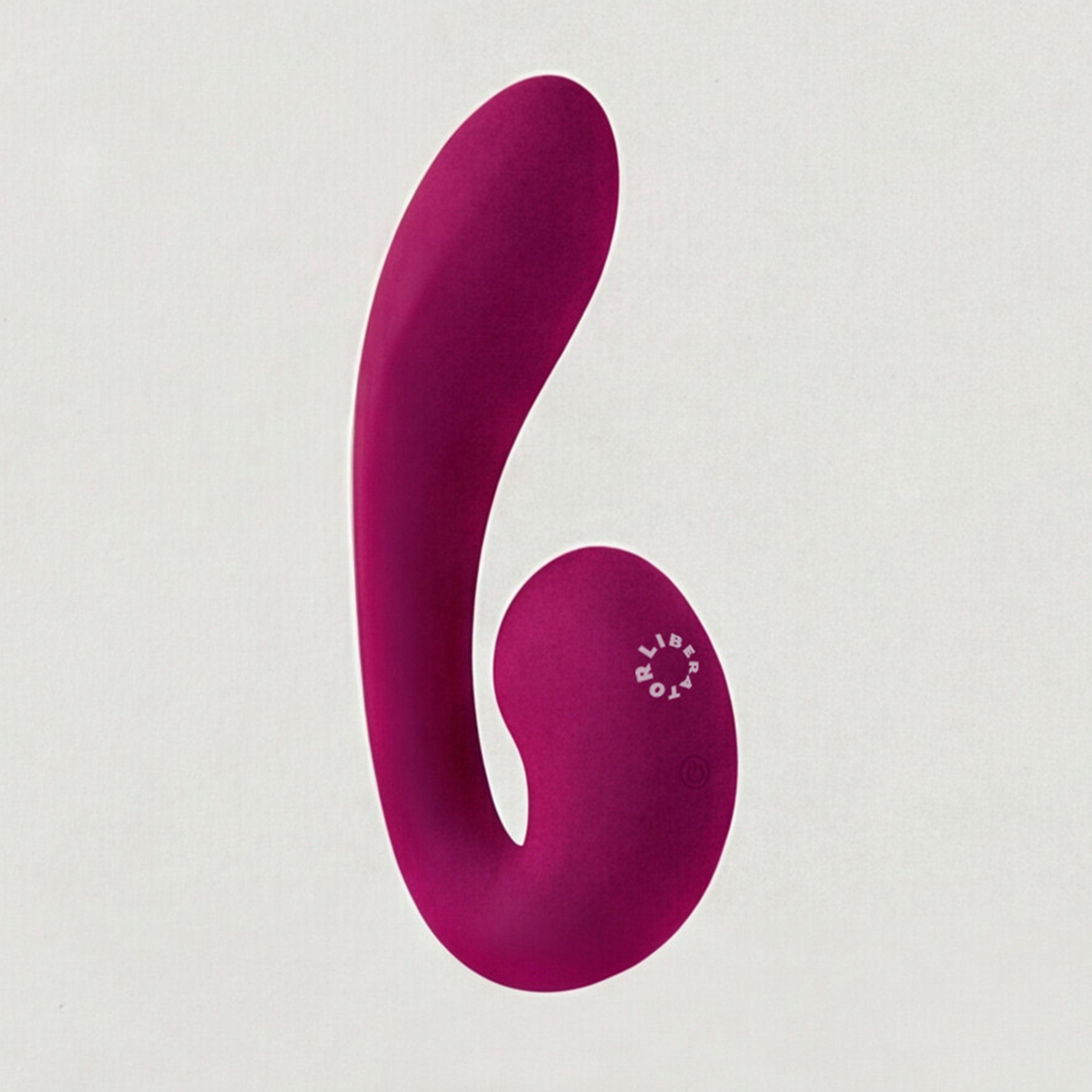 Pink silicone vibrator on a white background