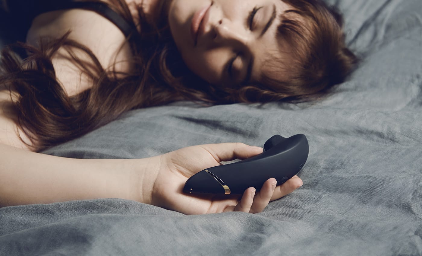 Womanizer Premium 2 Clitoral Stimulator with hand model for scale