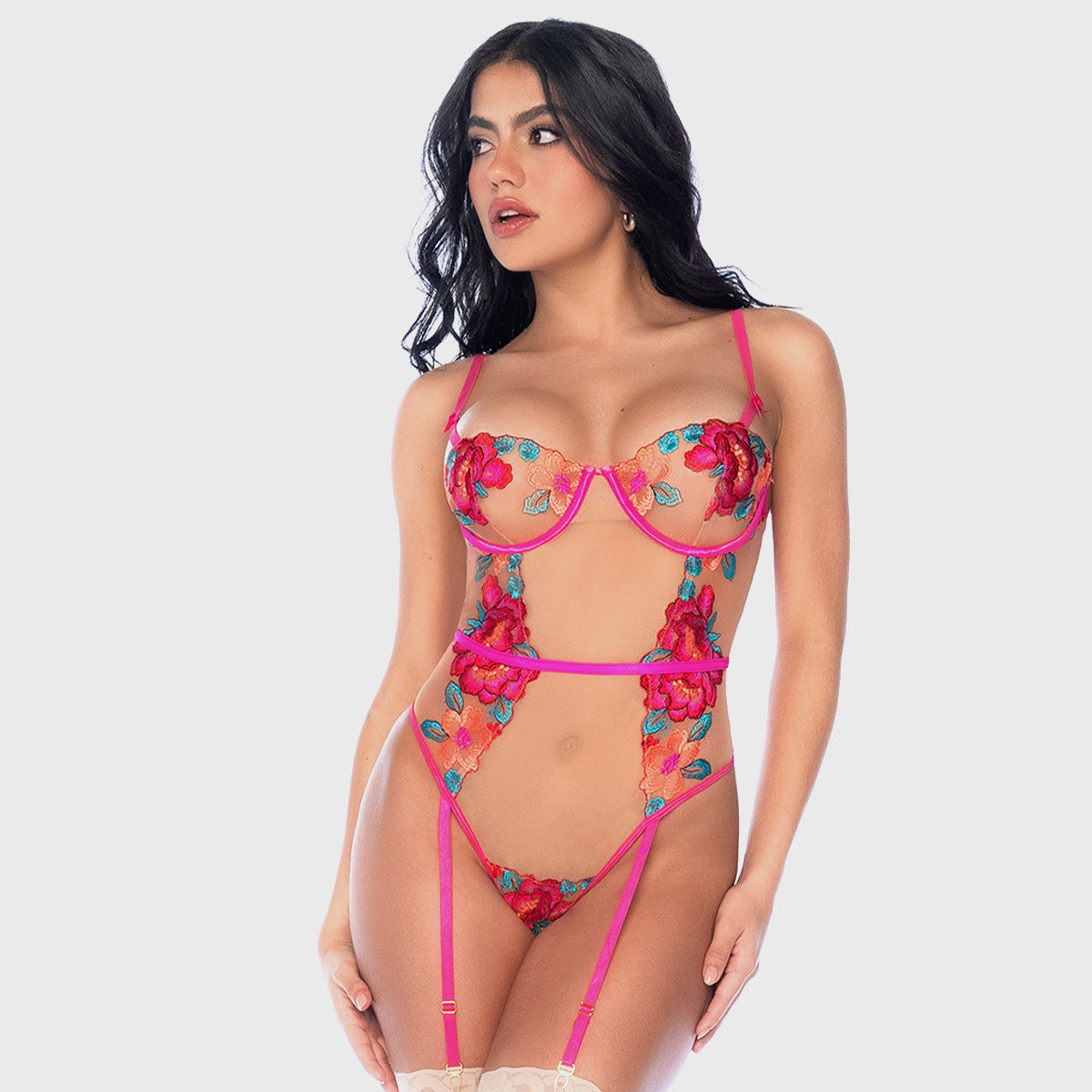 Woman wearing a floral lingerie set on a white background