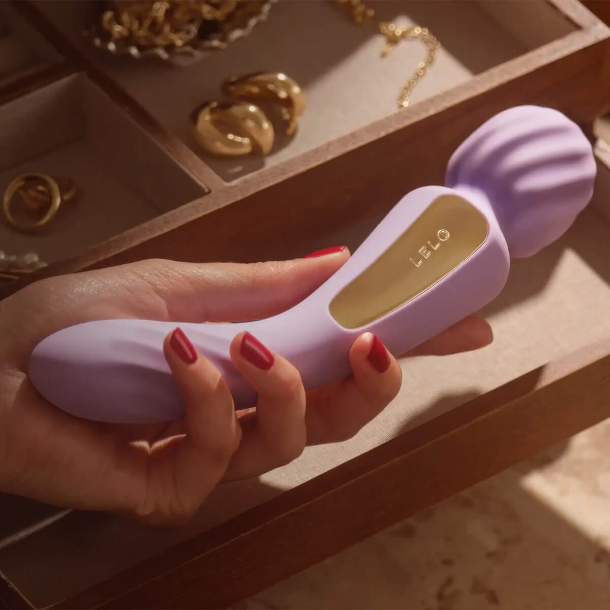Switch wand held in hand next to jewelry