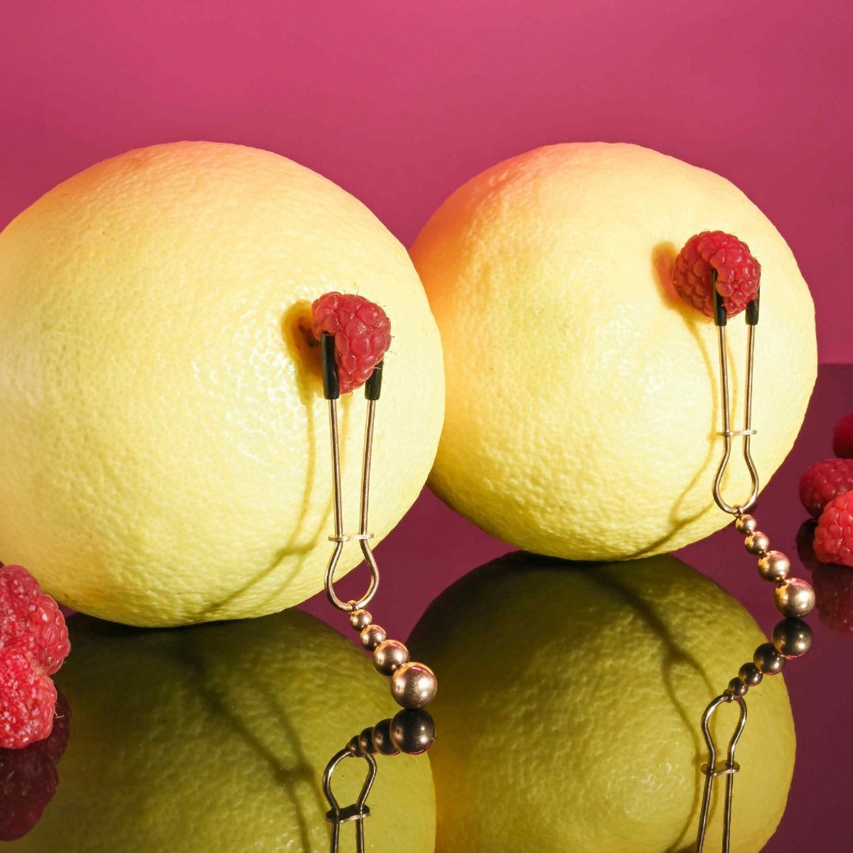 Selopa Beaded Nipple Clamps in Rose Gold clamped to fruit
