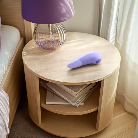 Womanizer Enhance on bedside table