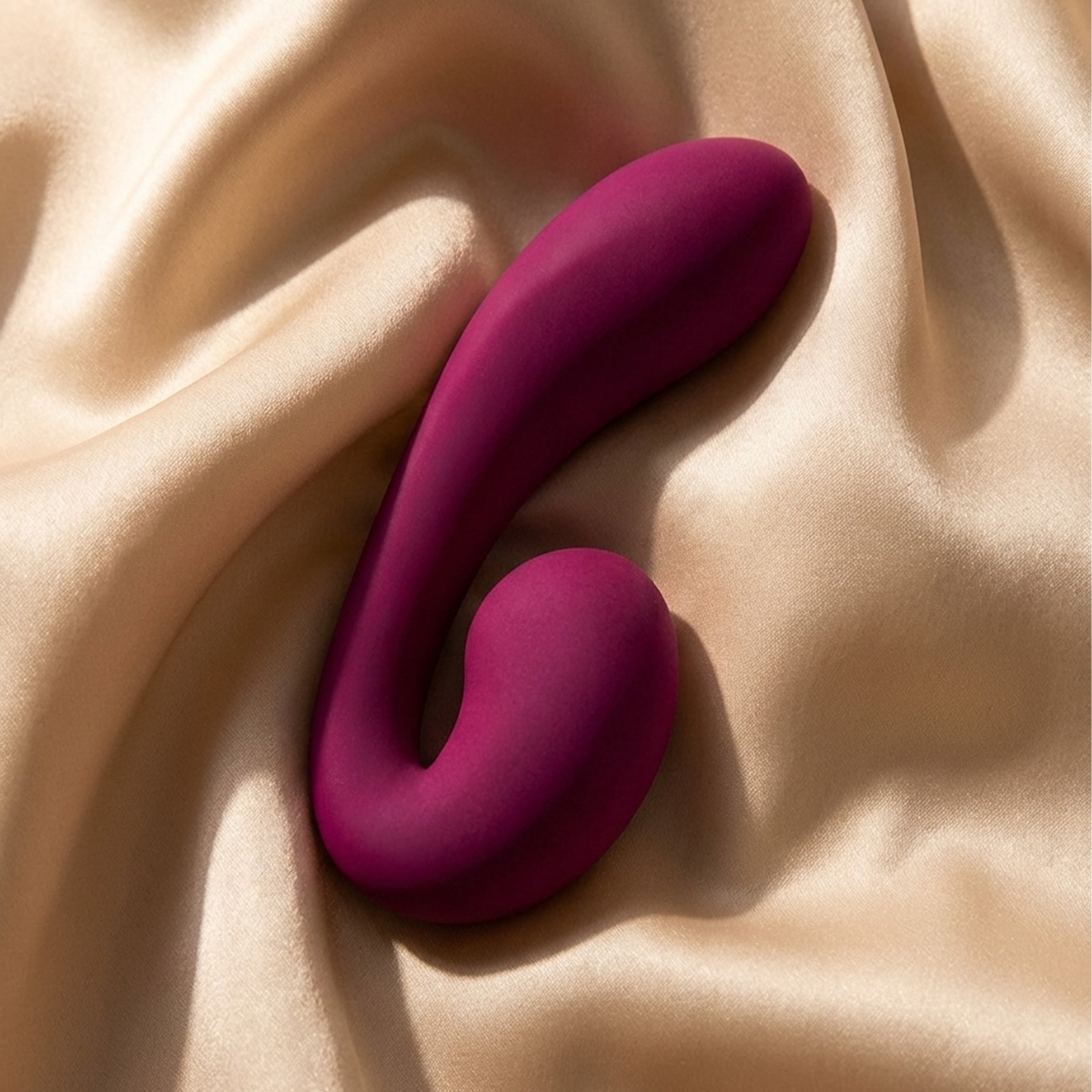 Pink silicone massager on beige fabric