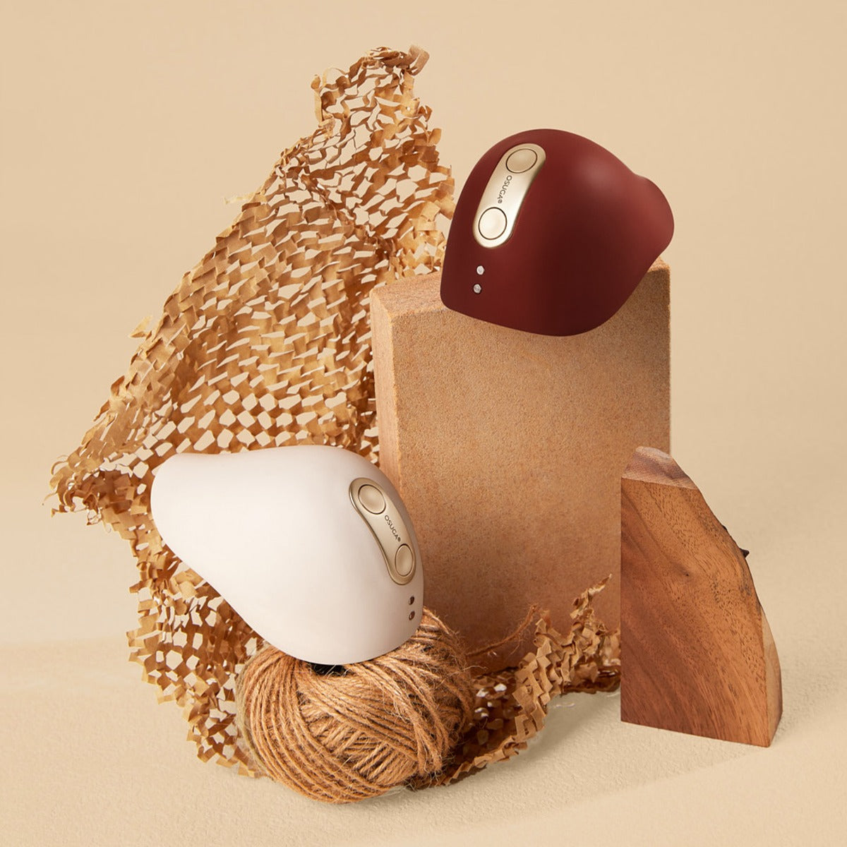 Chocolate and white colors of the Kiss vulva tapping and heated vibrators by Osuga on tasteful driftwood display
