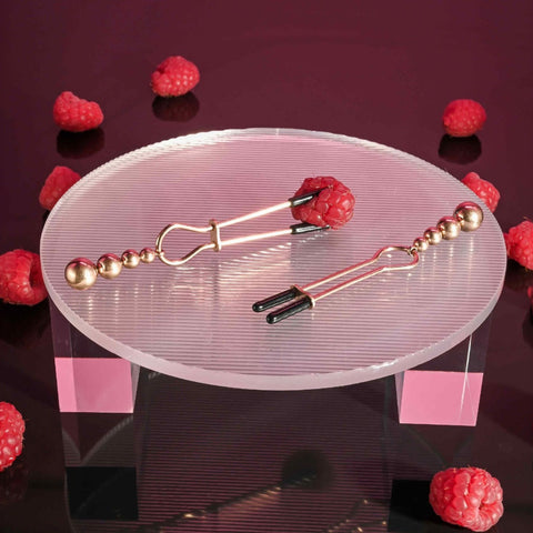 Selopa Beaded Nipple Clamps in Rose Gold on table