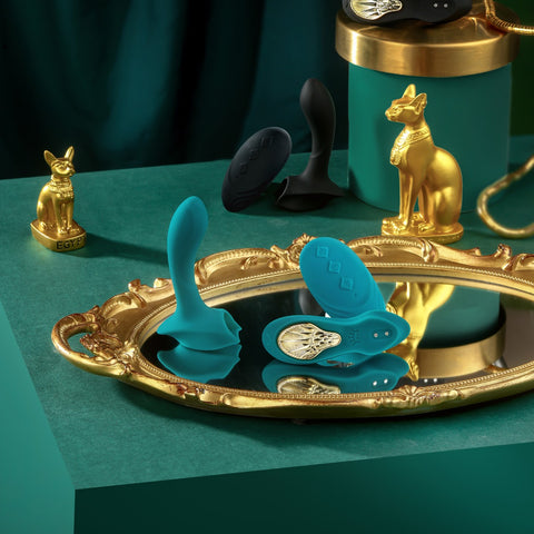 Zalo Aya VIbrator in pieces and different colors near Egyptian artifacts