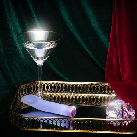 Oh My Gem Enrapture on table with gems and drink
