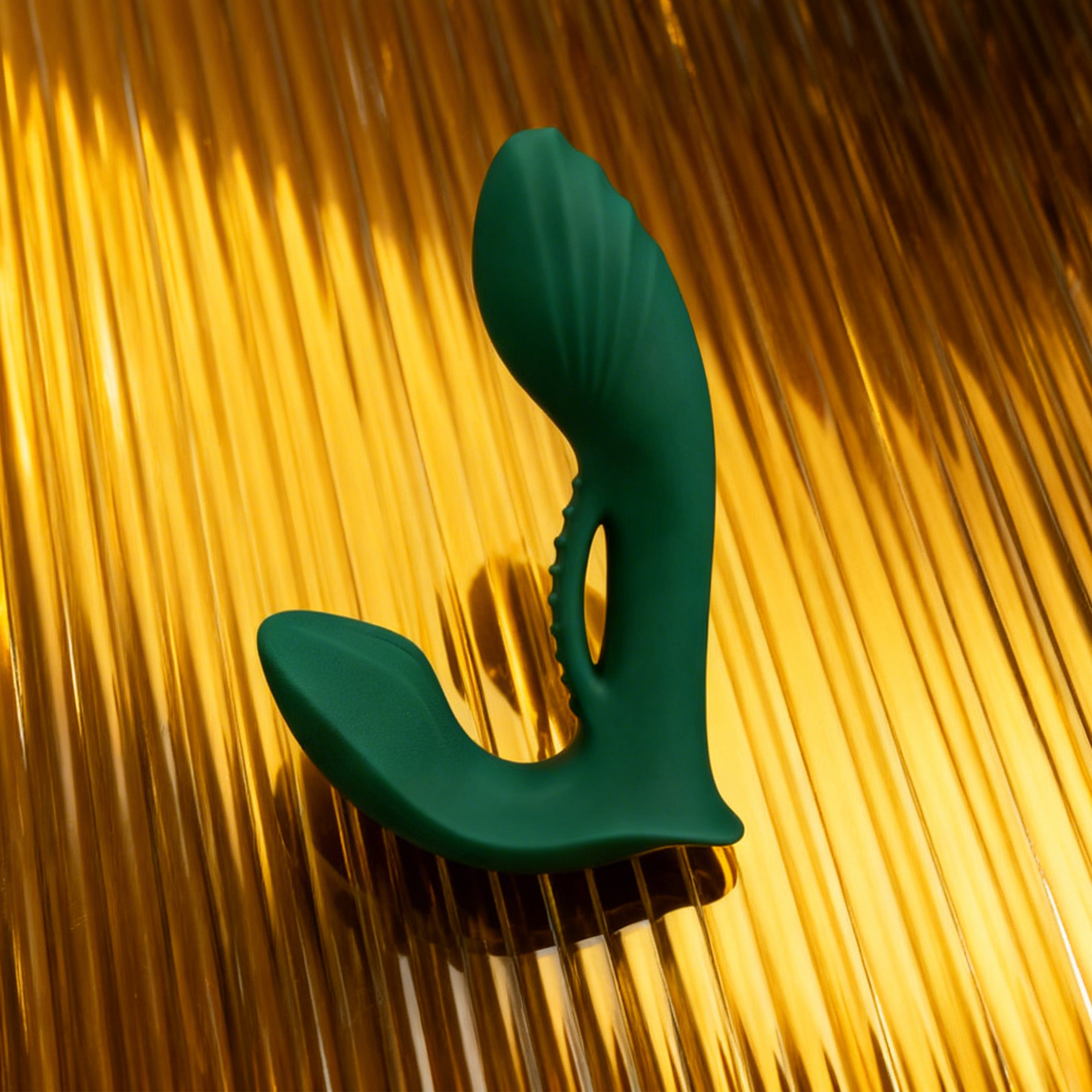 Green plastic tool on a gold metallic background