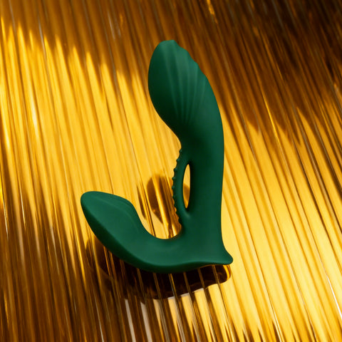 Green plastic tool on a gold metallic background