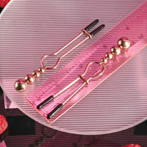 Selopa Beaded Nipple Clamps in Rose Gold against ruler 