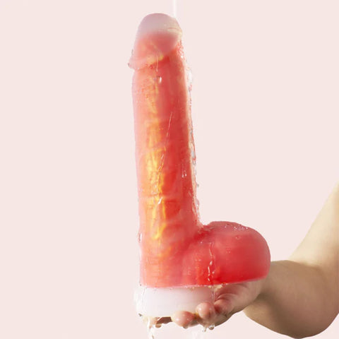 Hand holding Noctura dildo