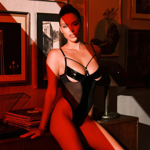 Woman sitting in Say No More cage teddy set next to records