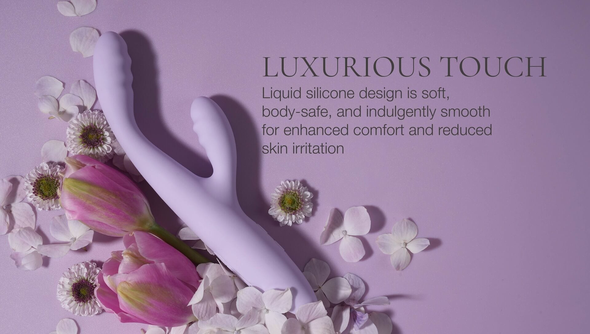 Silicone massager with flowers on a pink background