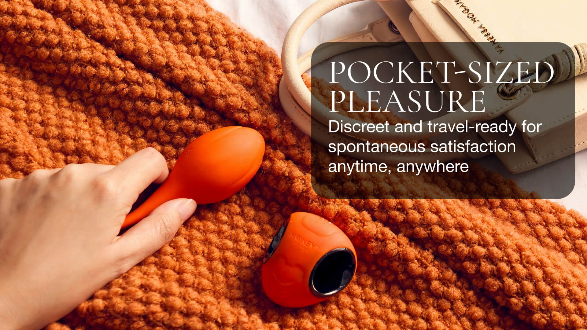 Hand holding an orange and black vibrator on an orange textured surface with promotional text overlay.