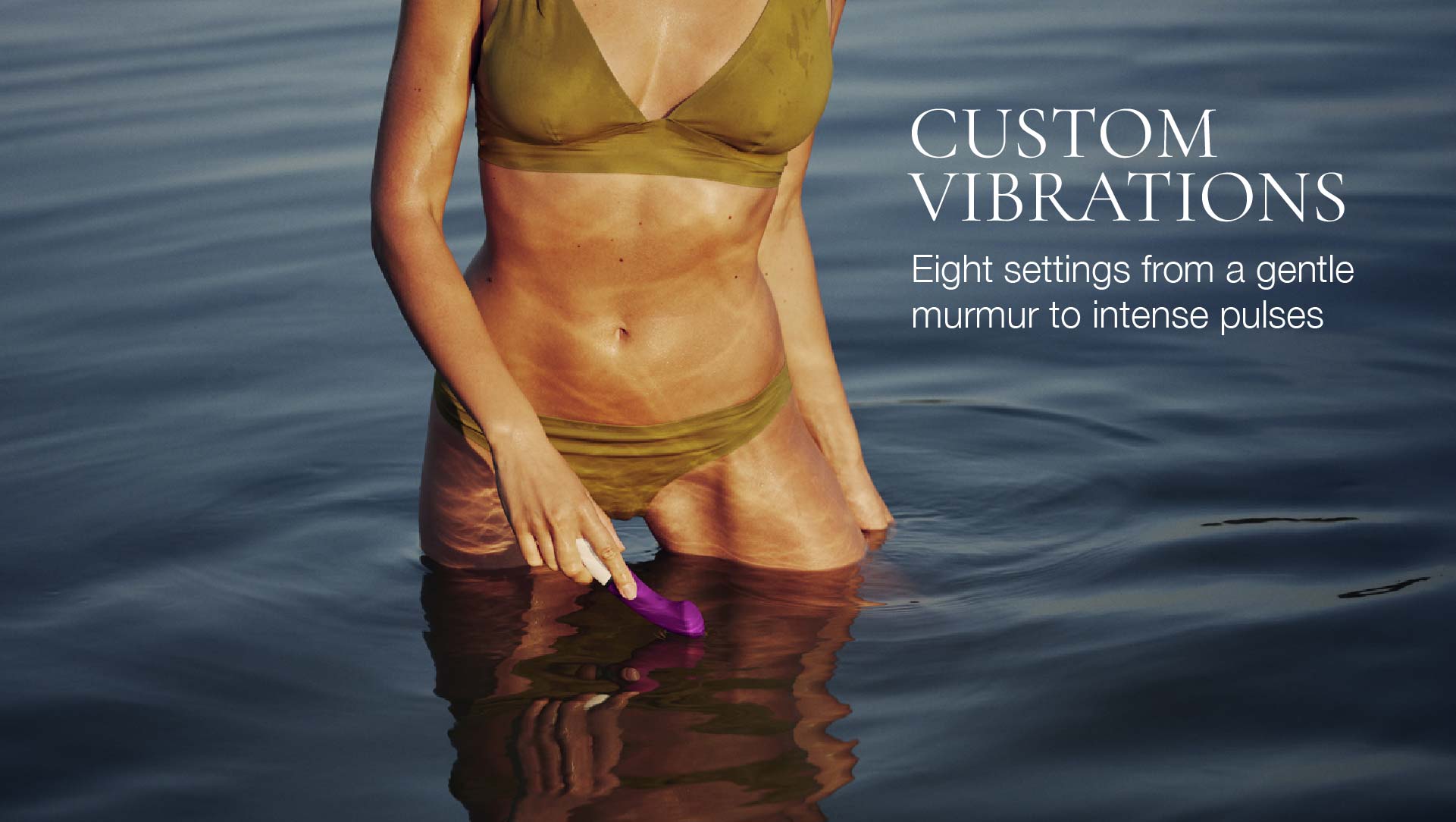 Person in green swimsuit holding a pink device in water with text about 'Custom Vibrations'.