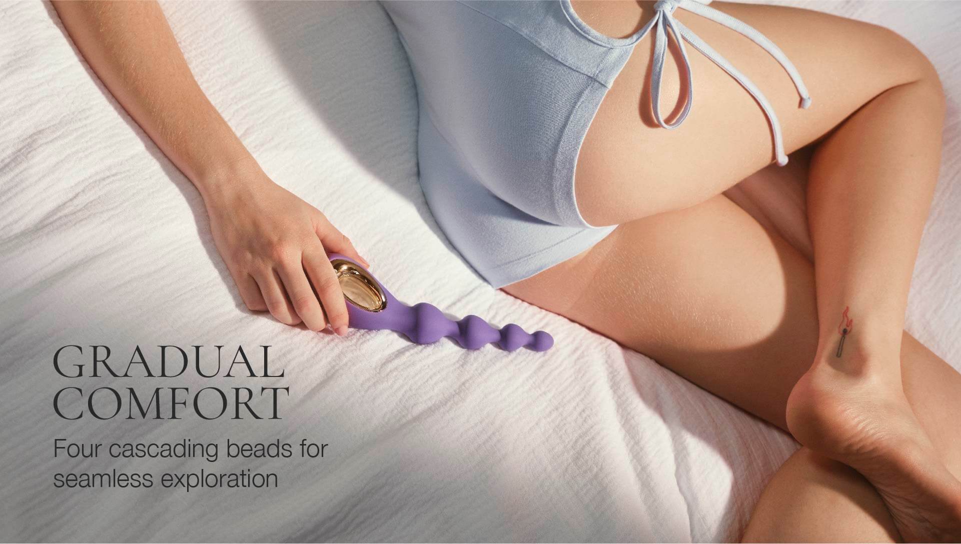 Person using a purple lubricant product on a white surface with text about comfort and beads.