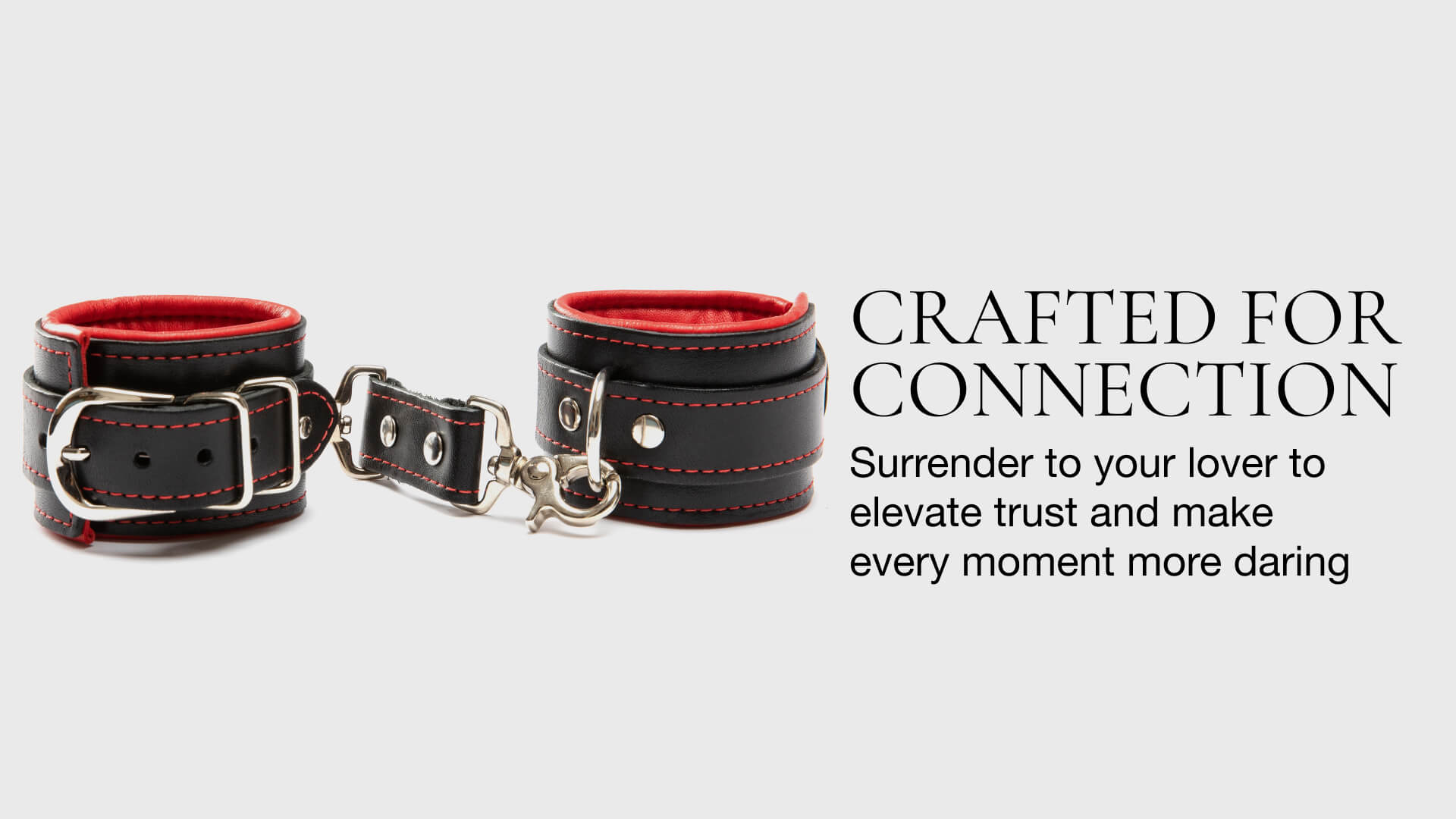 Pair of red and black leather cuffs on a light gray background with text about connection and trust.