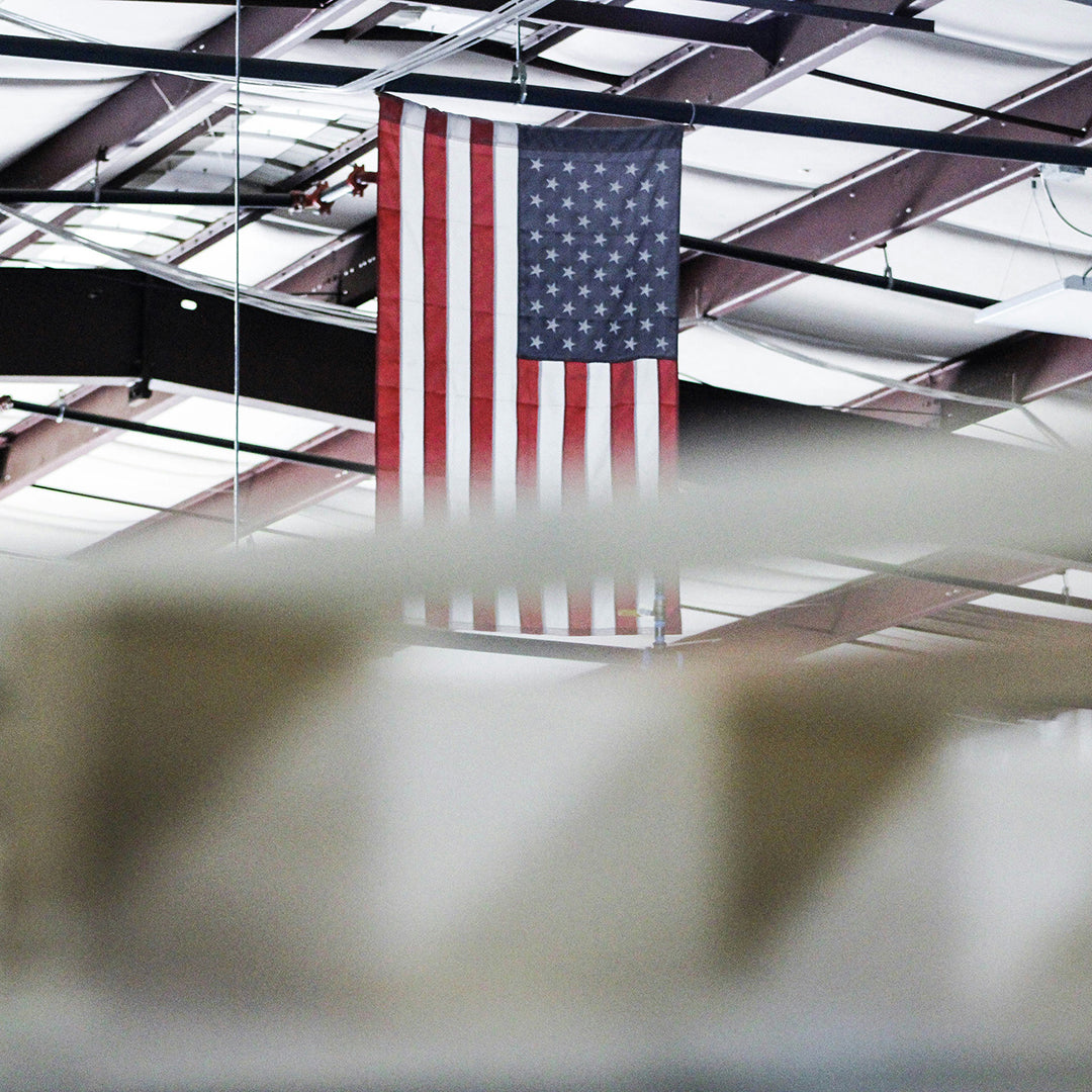 American flag hanging from a ceiling in an indoor setting