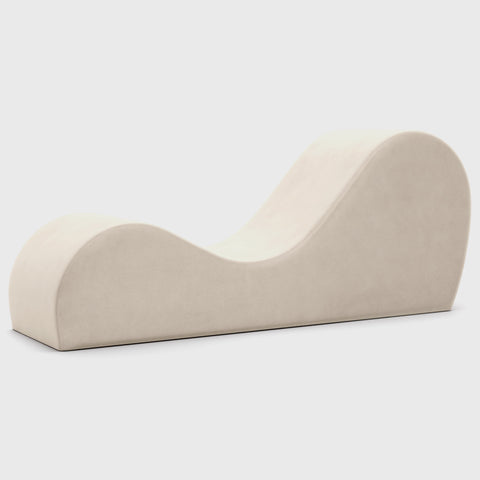 Beige curved chaise on a white background