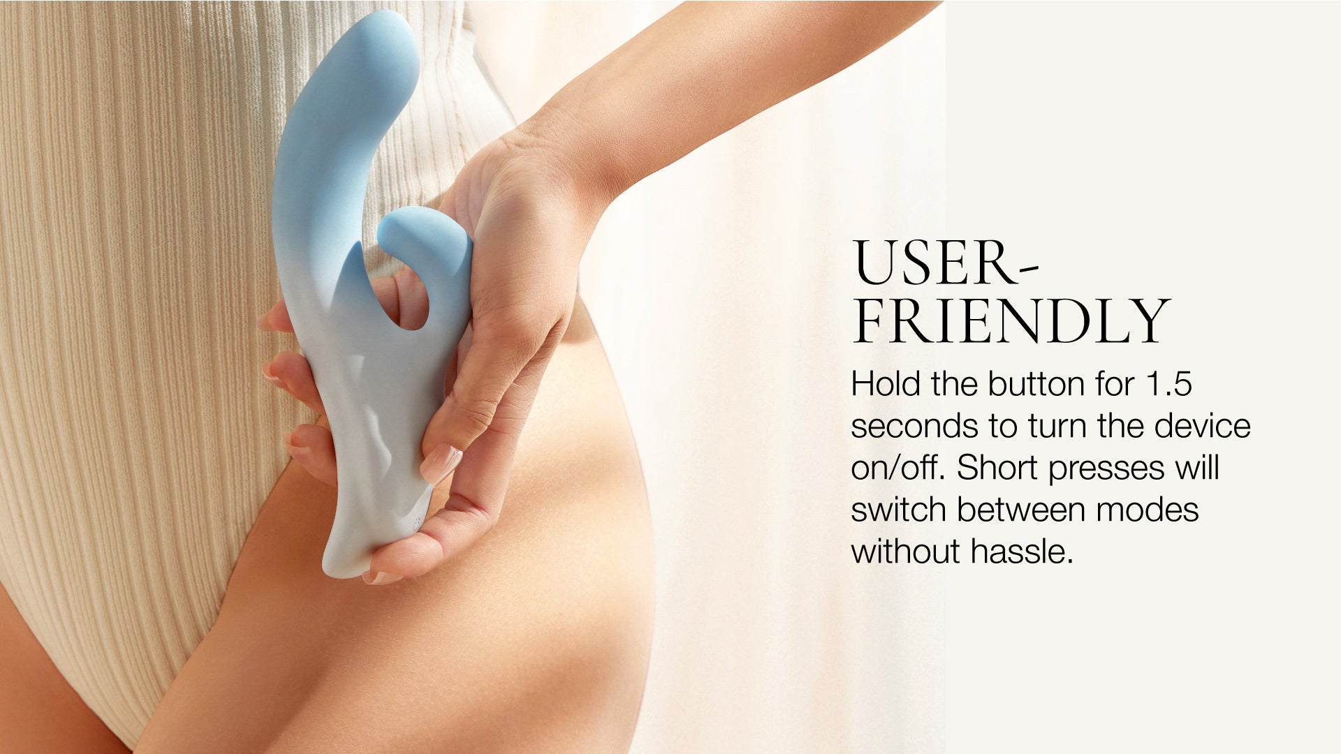 Hand holding a blue vibrator wand against a light background with text about user-friendliness.