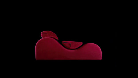 Red esse chaise on a black background
