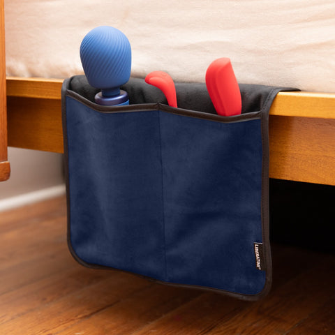 Fascinator Bedside Toy Storage Caddy hanging on side of bed with sex toys in pockets