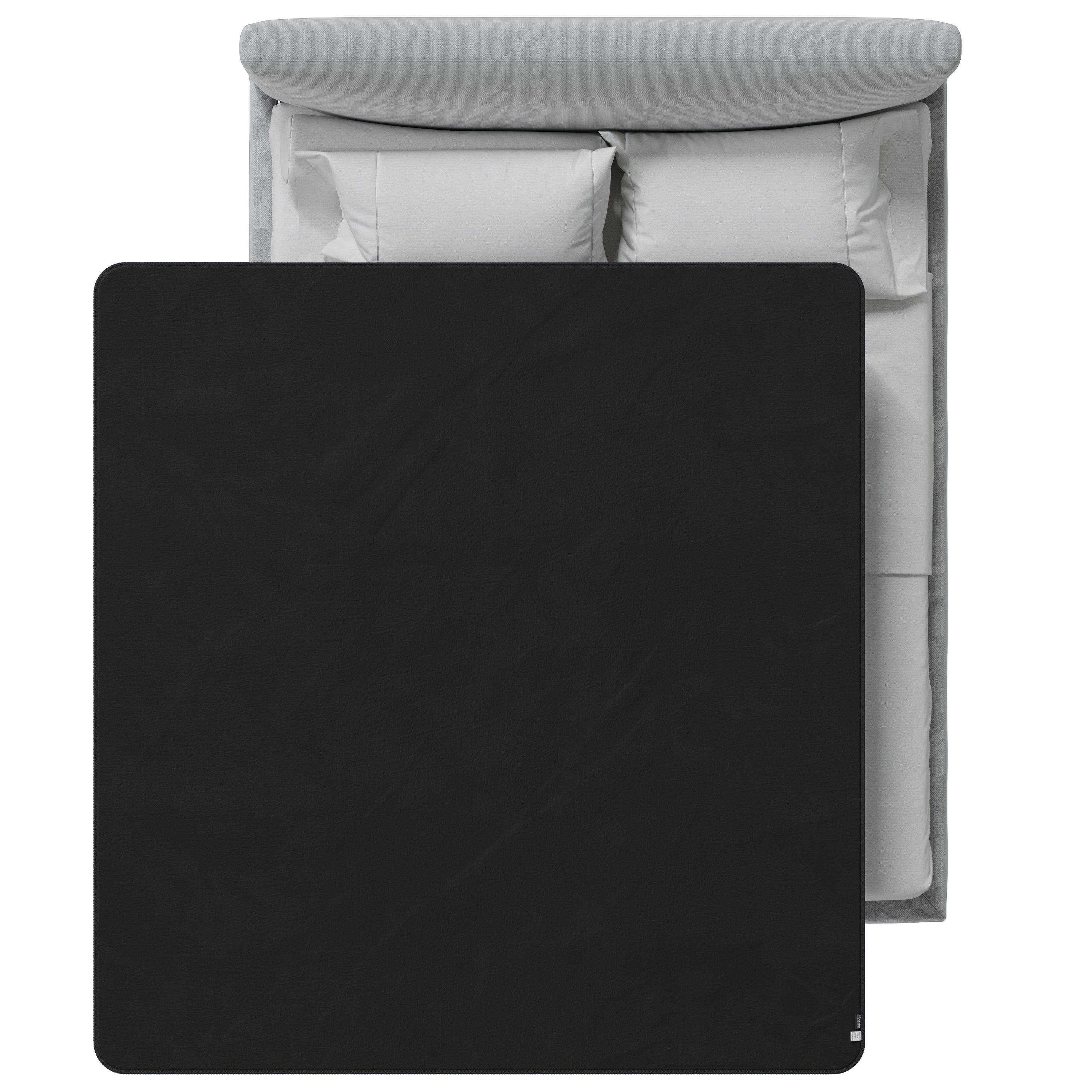 Black blanket on a bed with white bedding