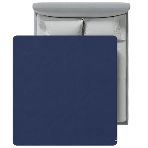 Blue blanket on a bed with white bedding