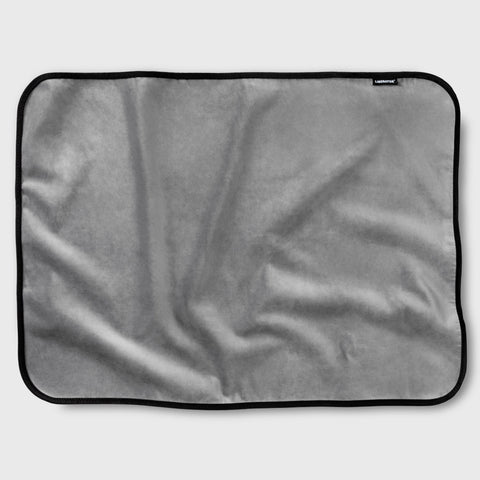 Gray blanket with a brand label on a light gray background