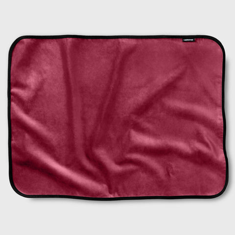 Red blanket with black border on a white background