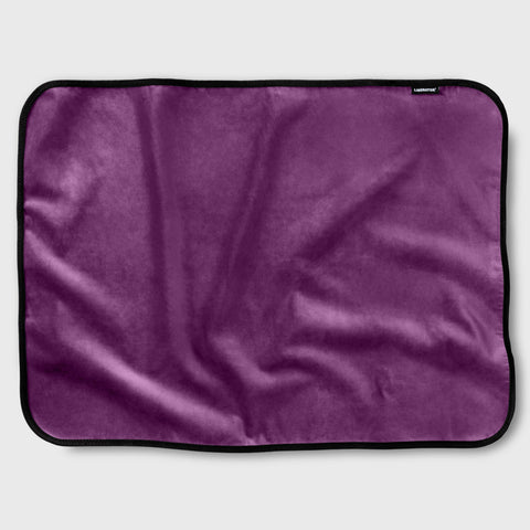 Purple blanket with a brand label on a light gray background