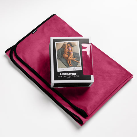 Pink fabric with a box labeled 'Liberator' on top, on a white background
