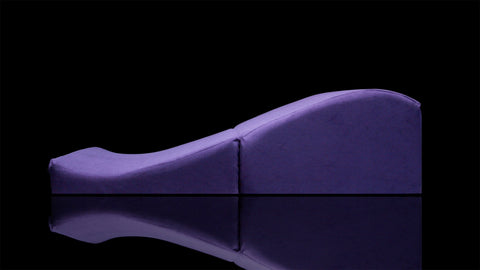 Purple wedge-shaped foam product on a black background