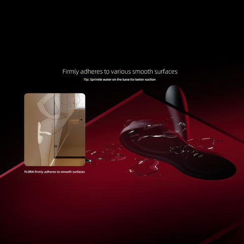 Zalo Flora App-Enabled Lay On Vibrator on a red and black gradient background  with the words Firmly adheres to various smooth surfaces. Tip: Sprinle water on the base for better suction.
