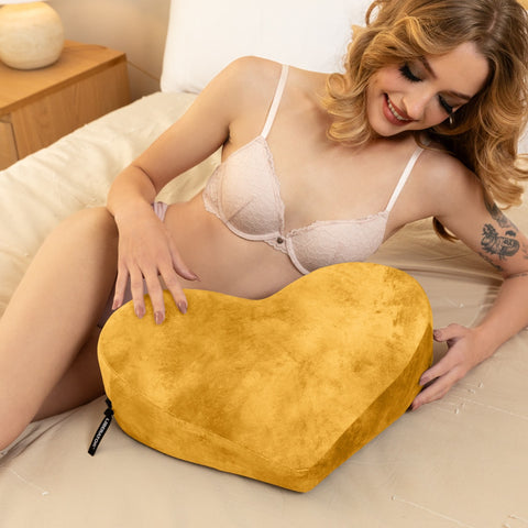 Liberator Heart Wedge Ibiza Golden color in the arms of a girl lying down
