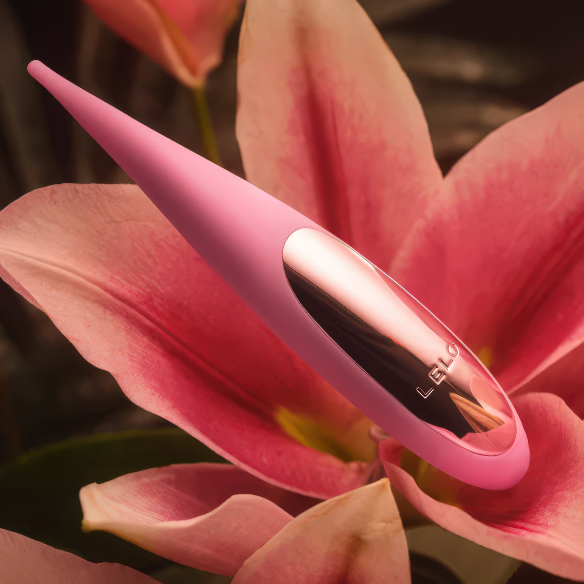 Pink electronic device with 'Lelo' branding on a pink flower background