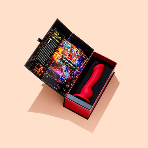 Impressions | Las Vegas Curve Vibrating P-Spot Dildo open package showing the Vegas strip on the inside flap