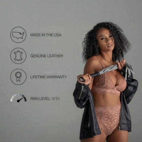 Woman holding a leather flogger with product features listed on a gray background