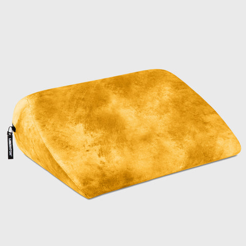 Yellow wedge pillow on a light gray background